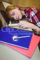 Blonde student sleeping on laptop