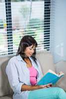Casual happy woman reading book