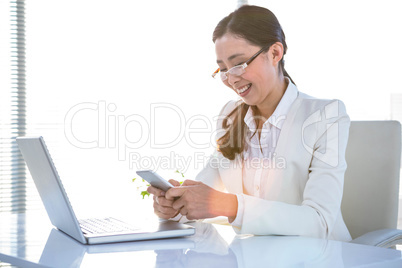 Smiling business woman using smartphone