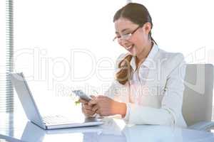 Smiling business woman using smartphone