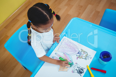 Girl drawing in her colouring book