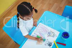 Girl drawing in her colouring book