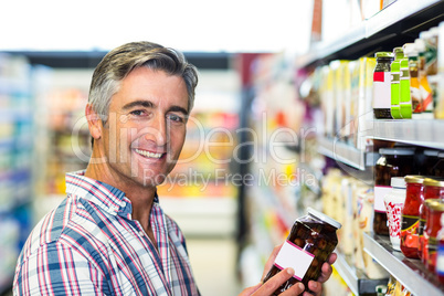 Smiling man holding jar