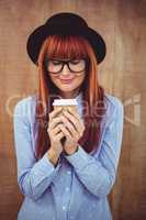 Smiling hipster woman drinking coffee