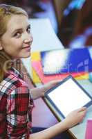 Blonde student using tablet during class