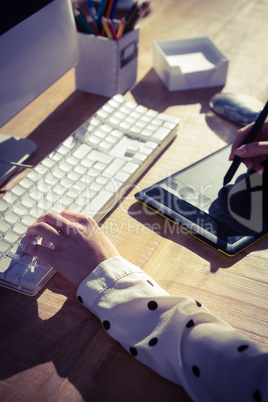 Cropped image of woman using graphics tablet