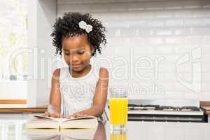 Smiling girl reading a book