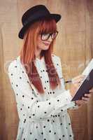 Attractive hipster woman writing on notepad