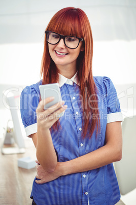 Smiling hipster woman using smartphone