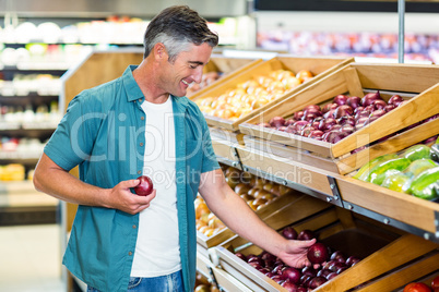 Smiling man choosing a onion
