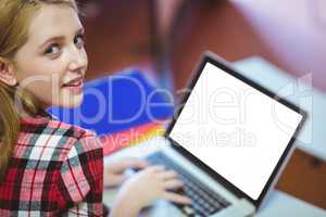 Blonde student using laptop during class