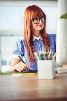 Attractive hipster woman using graphics tablet