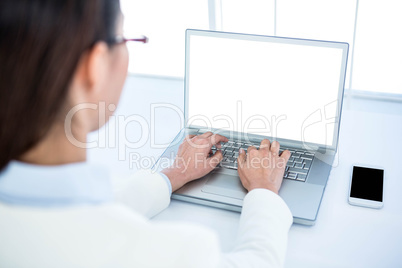 Rear view of businesswoman using laptop Rear view of businesswoman using laptop
