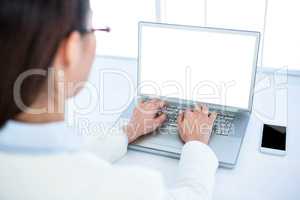 Rear view of businesswoman using laptop