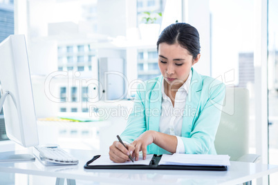 Smiling businesswoman with notes at desk