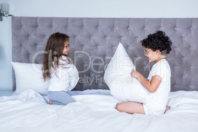 Siblings pillow fighting