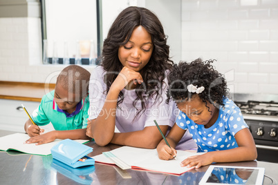 Mother with her children in kitchen