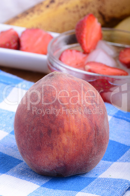 peach strawberry bananas mandarin close up as health food concept