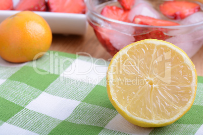 Close up of a cup of sliced strawberries with lemon