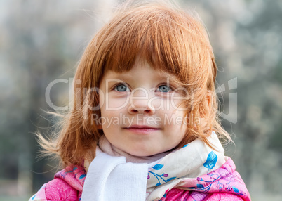 Portrait of a beautiful little girl in the park