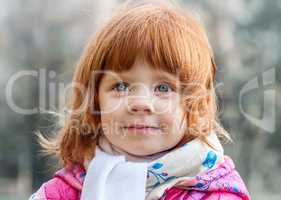 Portrait of a beautiful little girl in the park