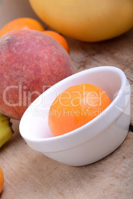 Mandarin Apples Bananas Peach on wooden plate