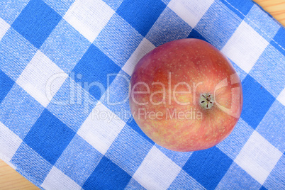 Red apple top view on blue material background
