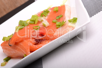 Salted salmon fillet with parsley leaf on the white bowl