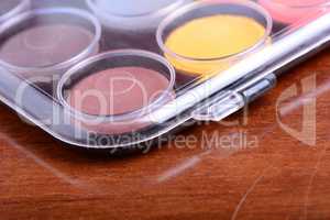 Watercolor paints set on wooden background