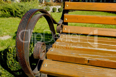 Forged metal armrests with wooden park bench