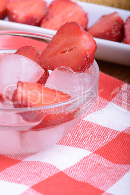 A slice of red strawberry on glass plate in party theme background