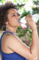 African American Woman Exercising Drinking Water Bottle