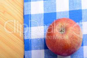 Red apple top view on blue material background