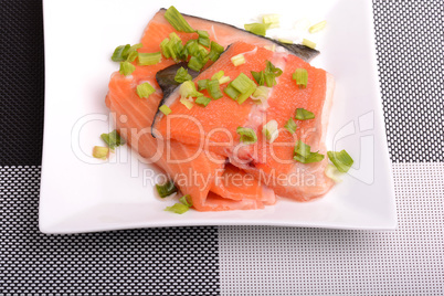 Salted salmon fillet with parsley leaf on the white bowl