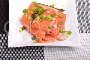 Salted salmon fillet with parsley leaf on the white bowl
