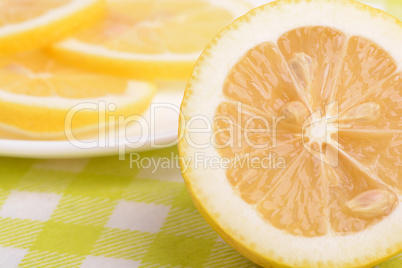 Background of yellow ripe lemons. A slice of lemon.