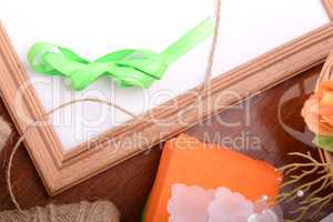 Christmas gift box and empty wooden frame on wooden table