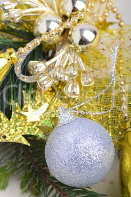 festive golden christmas decoration, candles, white balls, green fir tree branch, close up