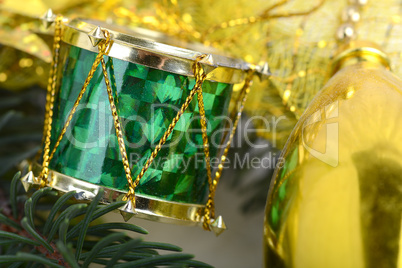 Christmas background with drums, green eve tree branch, golden new year decoration