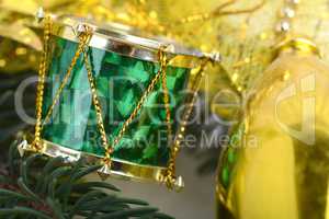 Christmas background with drums, green eve tree branch, golden new year decoration