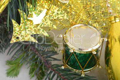 Christmas background with drums, green eve tree branch, golden new year decoration