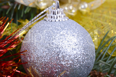 Closeup of Christmas balls and green fir tree branch, new year invitation card