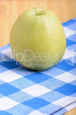 Fresh green apple on blue material backgound