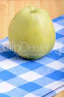 Fresh green apple on blue material backgound