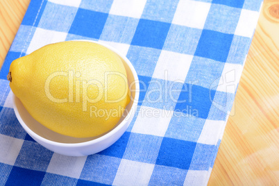 ripe lemons on a white plate