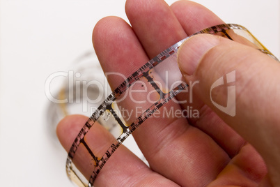 Old film strip in the man's hand