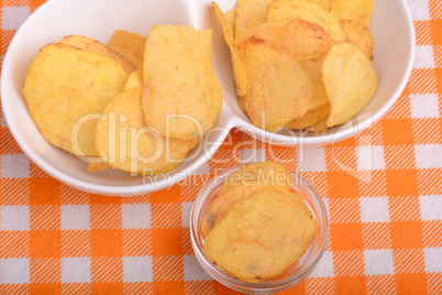 chips and peeled potato on a white plate