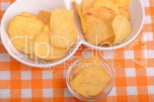 chips and peeled potato on a white plate