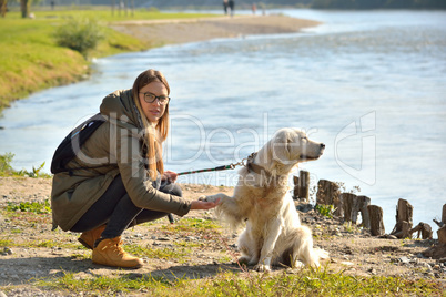 Girl and dog in crouching position