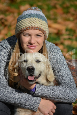 Girl hugging retriever dog